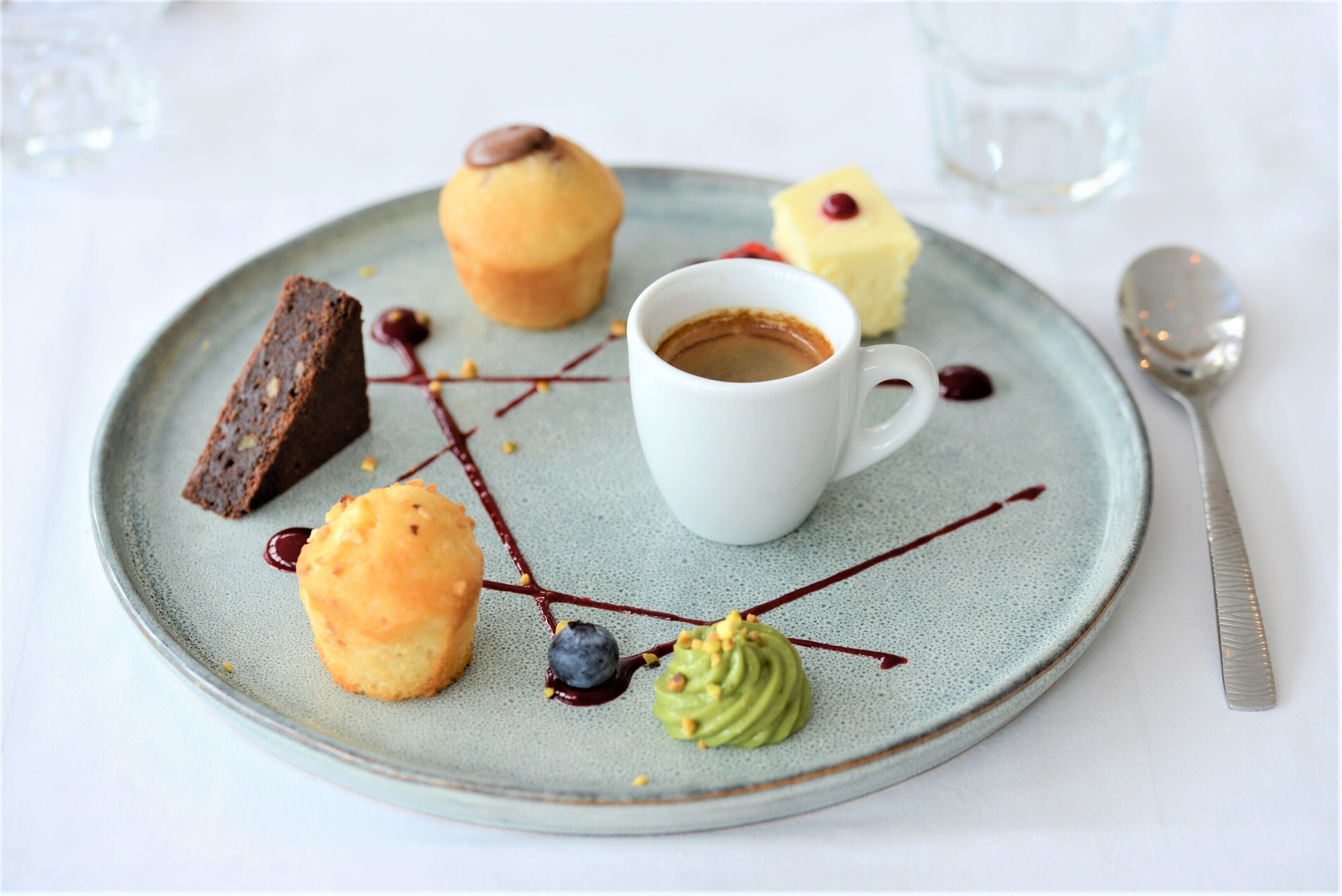 A dessert plate with various pastries and a cup of coffee.