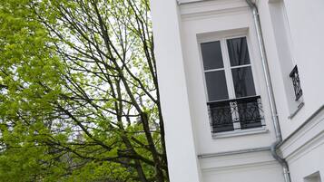 A white building with a window and a balcony.