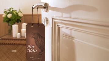 Une porte sur laquelle est accrochée une étiquette indiquant « pas maintenant » et « HÔTEL MONCE PARIS ».