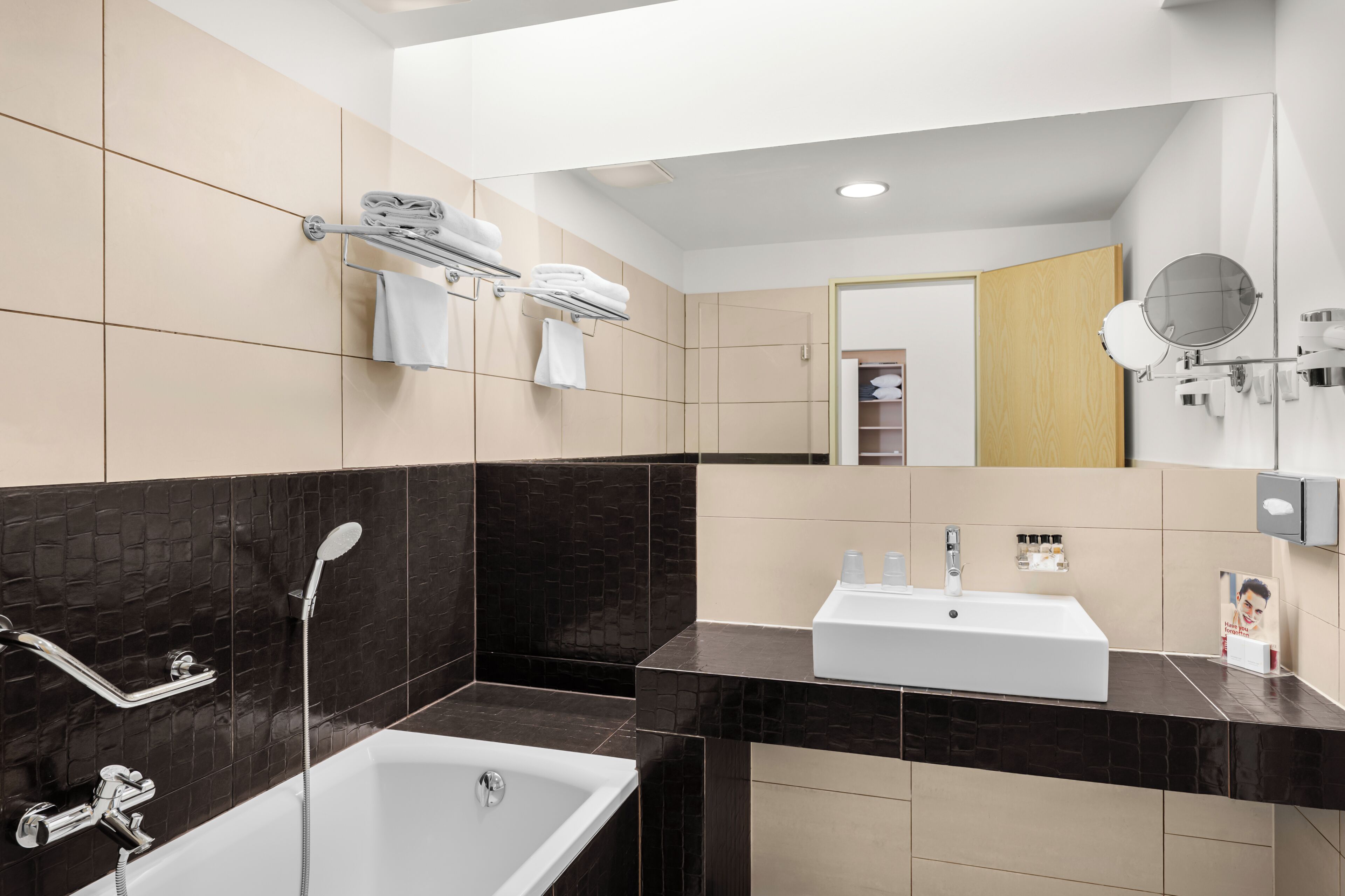 A modern bathroom with a bathtub, a sink, and a shower.