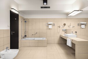 A modern bathroom with a bathtub, a sink, and a toilet.