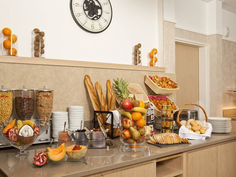 A breakfast buffet with various food items and beverages.
