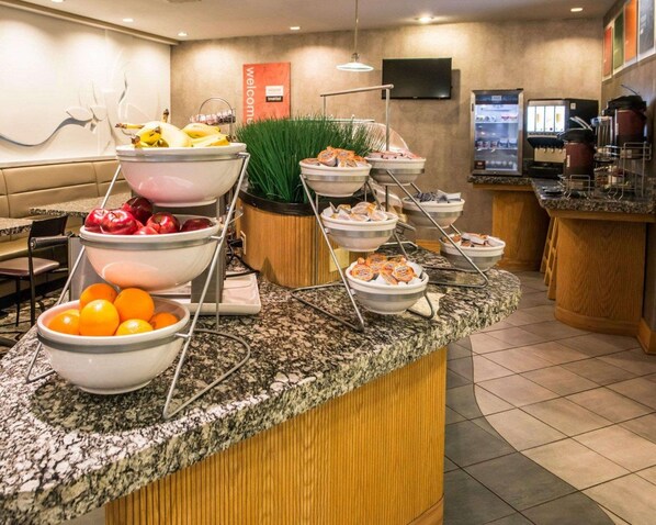 A buffet setup with various food items and a coffee station. - Comfort Suites Monroeville - Pittsburgh East (Monroeville)