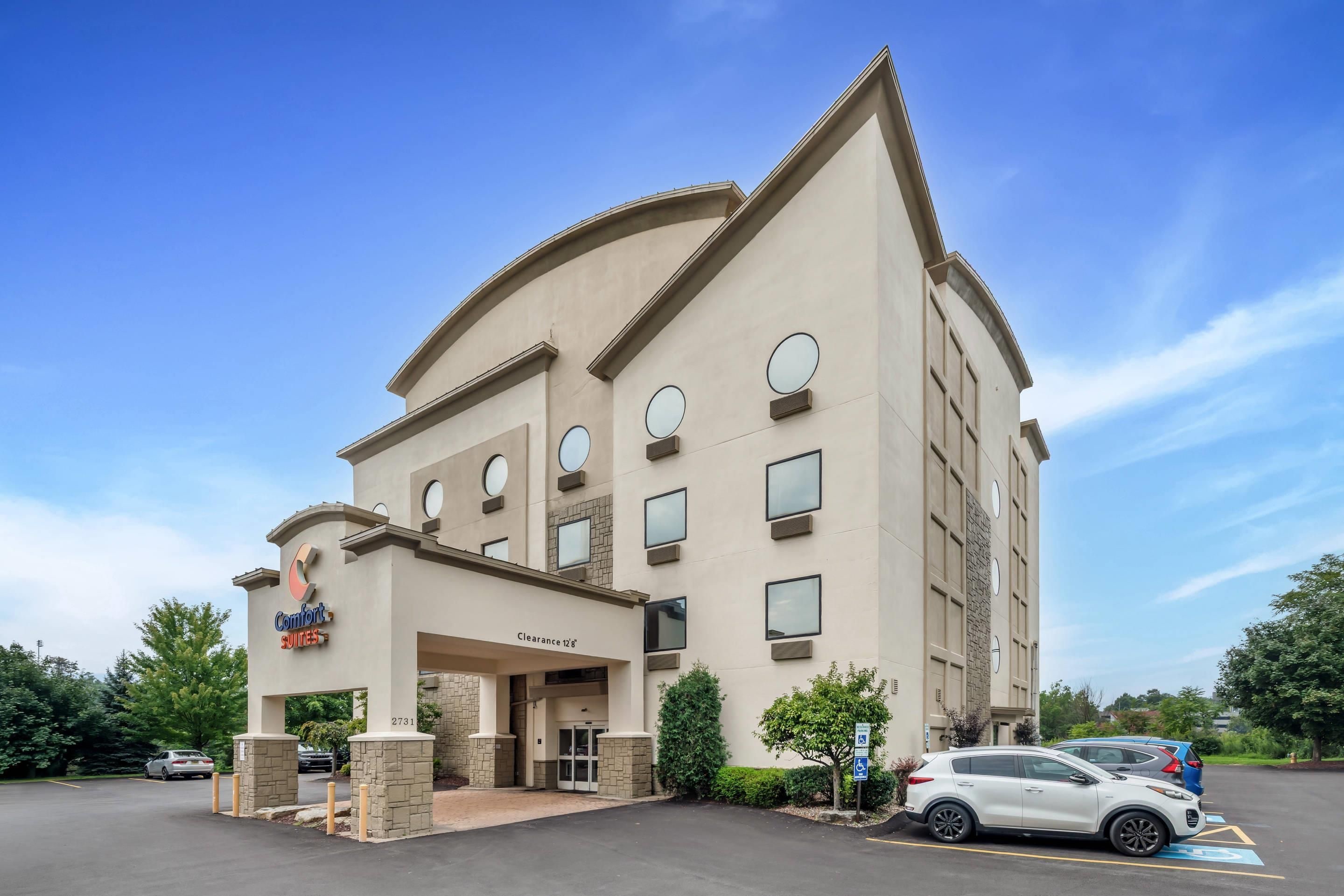 A hotel with a curved facade, multiple windows, and a clear sky.