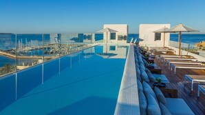 Una piscina infinita en la azotea con vistas despejadas del puerto deportivo y del mar.