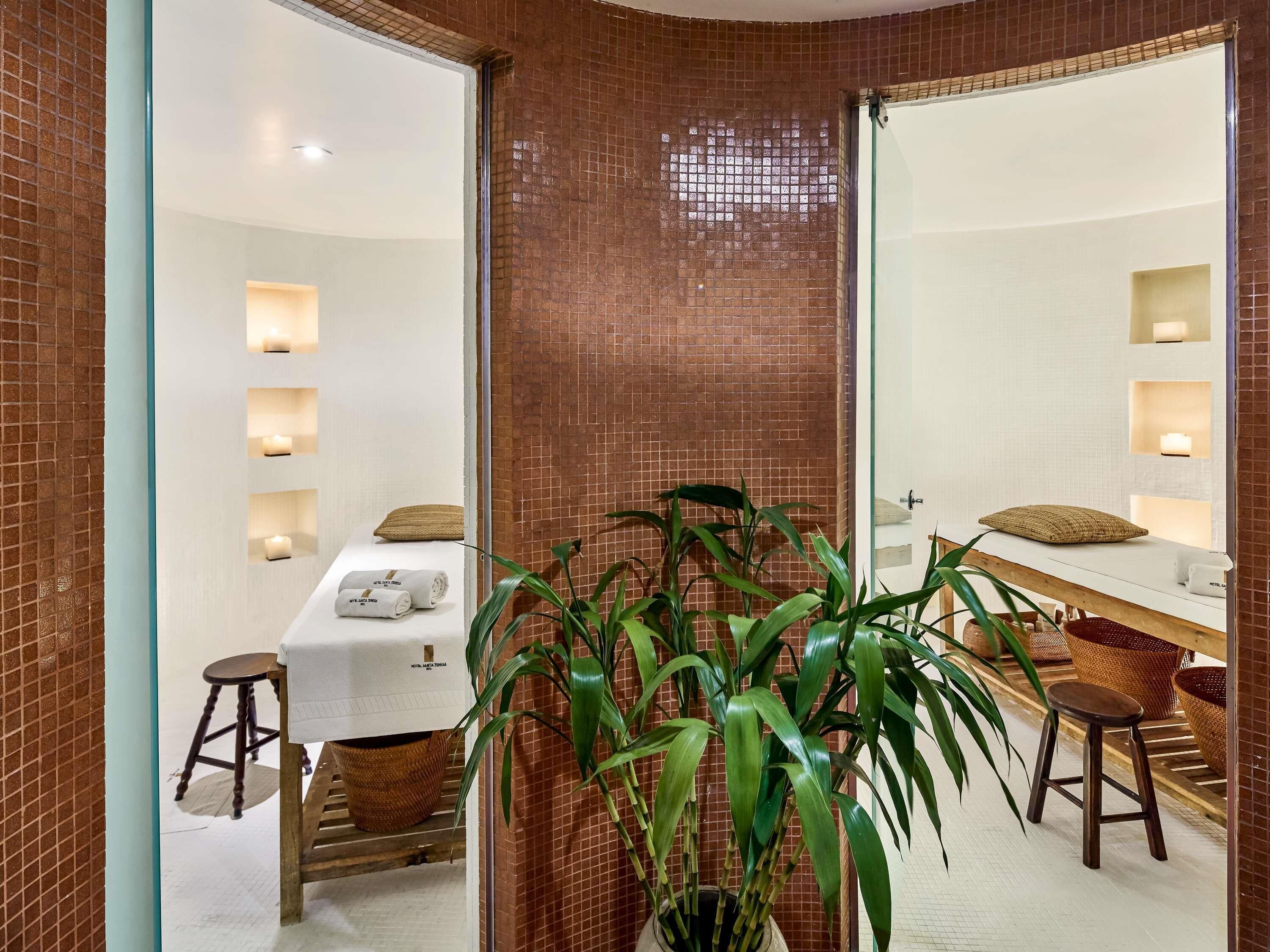 A bathroom with a mirror, towel rack, and a potted plant.