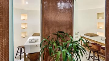 A bathroom with a mirror, towel rack, and a potted plant.