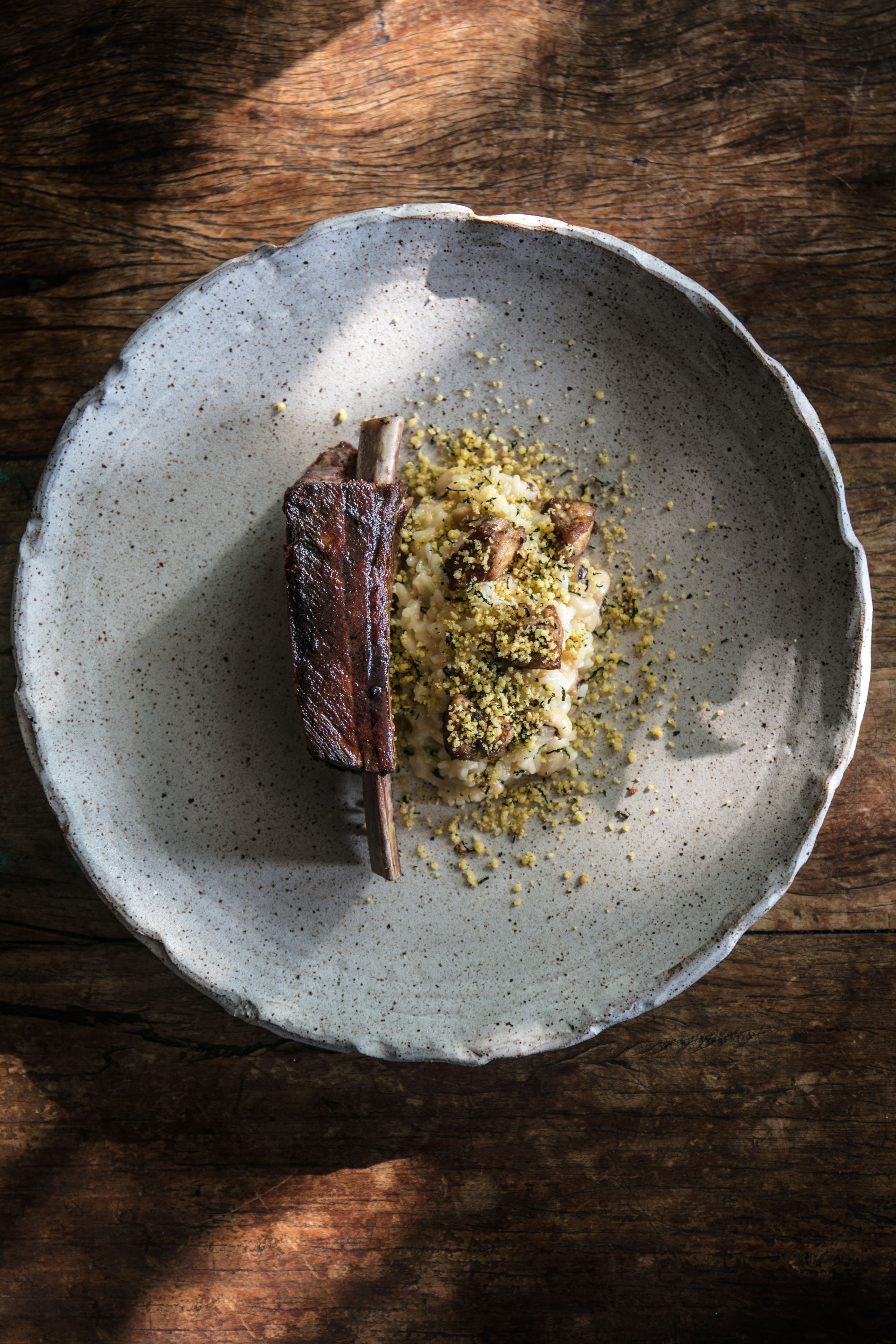 A rustic wooden table with a plate of food.