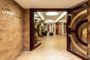 A hotel lobby with marble flooring, a reception desk, and a sign reading 'SPA Center'. - Hotel Mosaic (Istanbul)
