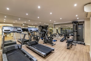 A gym with treadmills, weight machines, and a mirrored wall. - Hotel Mosaic (Istanbul)