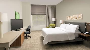 Premium bedding, desk, laptop workspace, blackout drapes