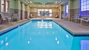 An indoor swimming pool with lounge chairs and exercise equipment. - Holiday Inn Express Hotel & Suites Clovis by IHG (Clovis)