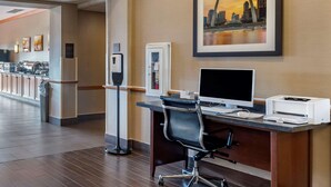 A hotel reception area with a computer desk, a printer, a coffee machine, and a framed cityscape picture on the wall. - Comfort Inn & Suites Greenville I-70 (Greenville)