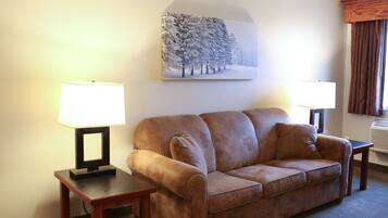 A living room with a brown sofa, two side tables with lamps, and a framed picture on the wall.