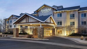 A Fairfield by Marriott hotel with a covered entrance, stone pillars, and multiple windows. - Fairfield Inn & Suites by Marriott Laramie (Laramie)