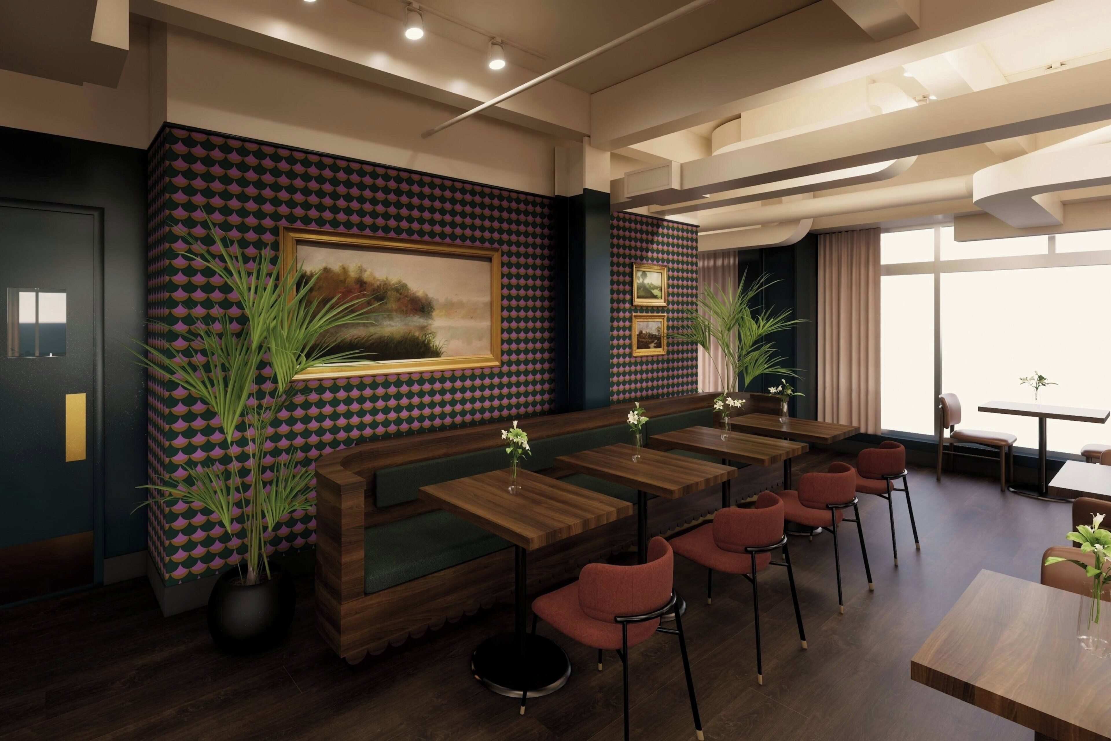 A modern restaurant with a patterned wall, wooden tables, and red chairs.