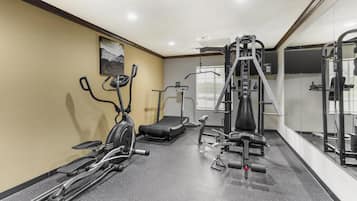 A gym with treadmills, elliptical machines, and weight equipment.