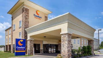 Welcome to Comfort Suites, featuring a modern design with a covered entrance and stone accents.