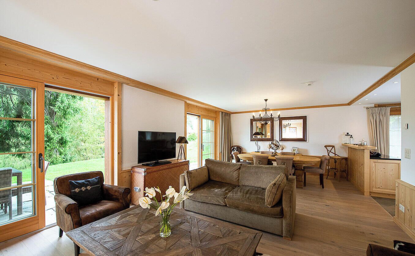 A cozy suite with a living area, dining space, and a kitchen.