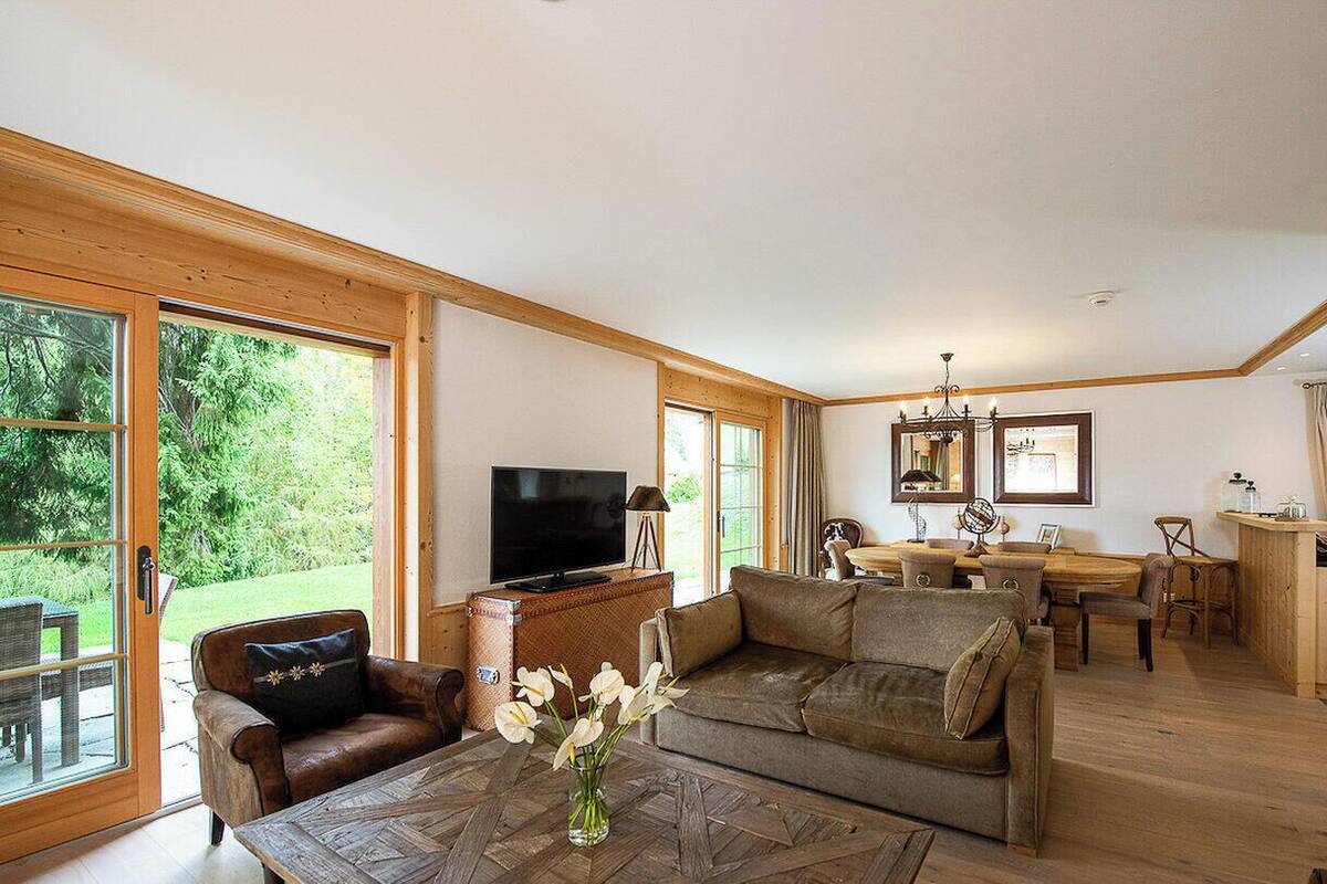 A cozy suite with a living area, dining space, and a kitchen.