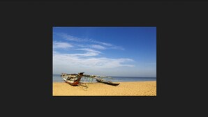 A boat on a sandy beach with a clear sky. - Ramada by Wyndham Katunayake Colombo International Airport (Seeduwa - Katunayake)