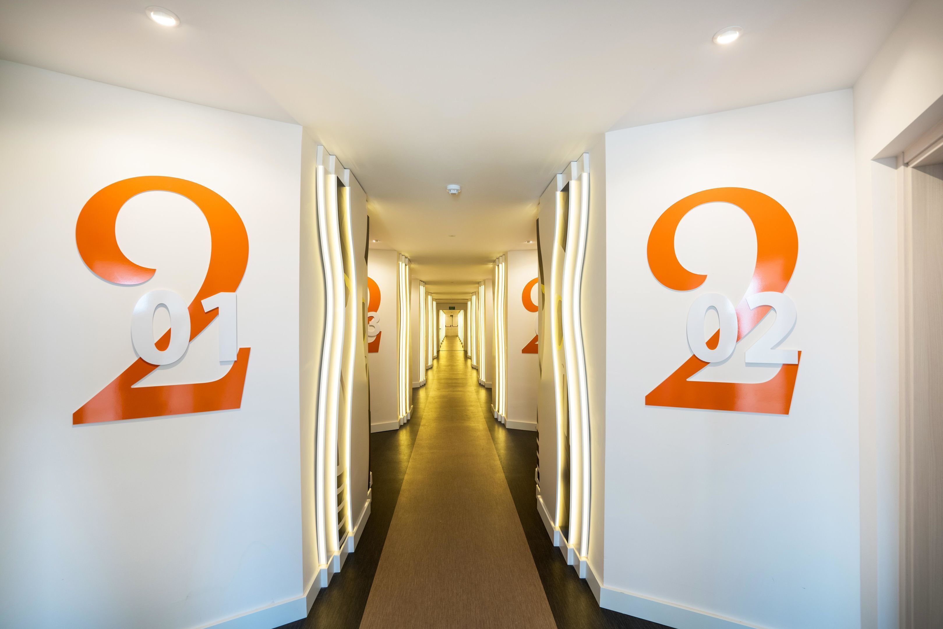 A hallway with large numbers '02' on the walls, indicating a specific floor or section.