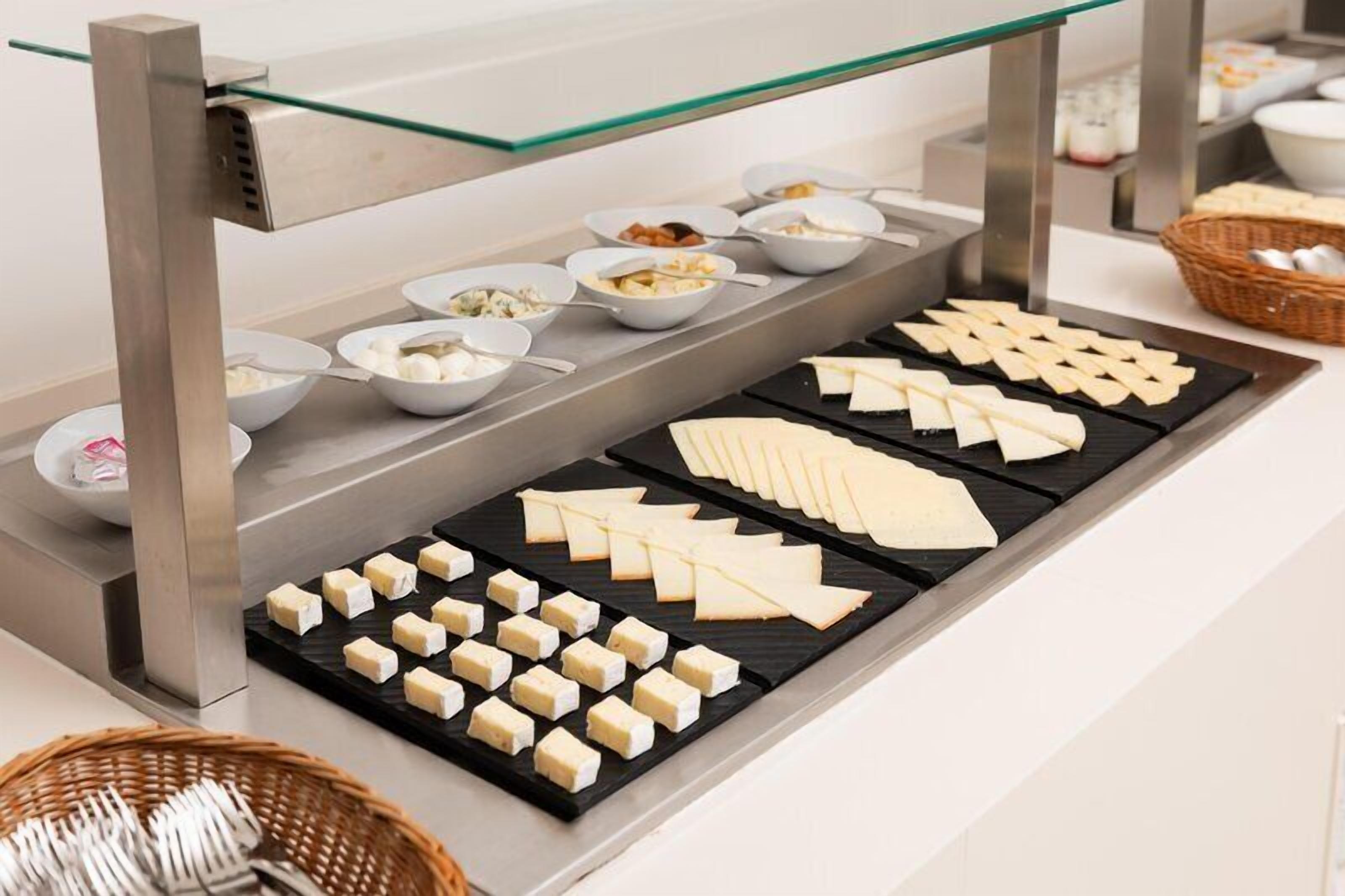 A buffet with various food items and utensils.