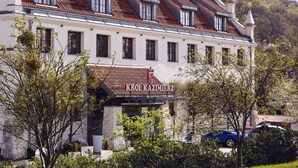 A building with a traditional architectural style, featuring a tiled roof and multiple windows.