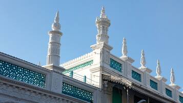 A white building with ornate architectural details, including multiple spires and decorative elements.