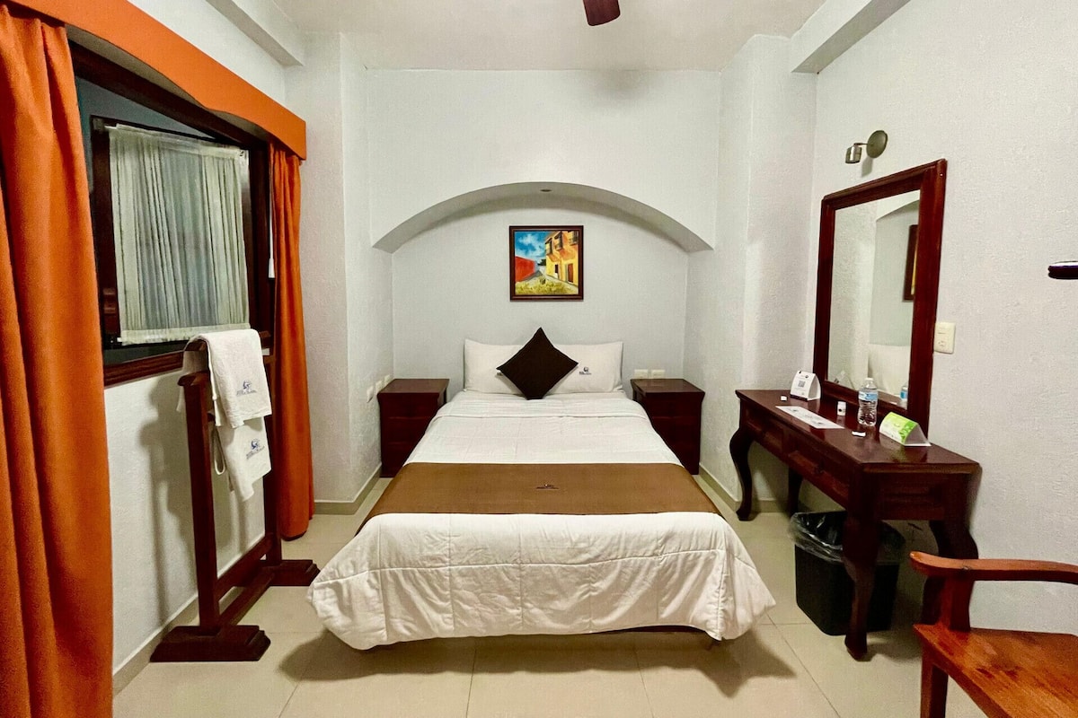 Premium bedding, desk, laptop workspace, blackout drapes