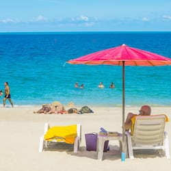 On the beach, white sand, sun-loungers, beach umbrellas