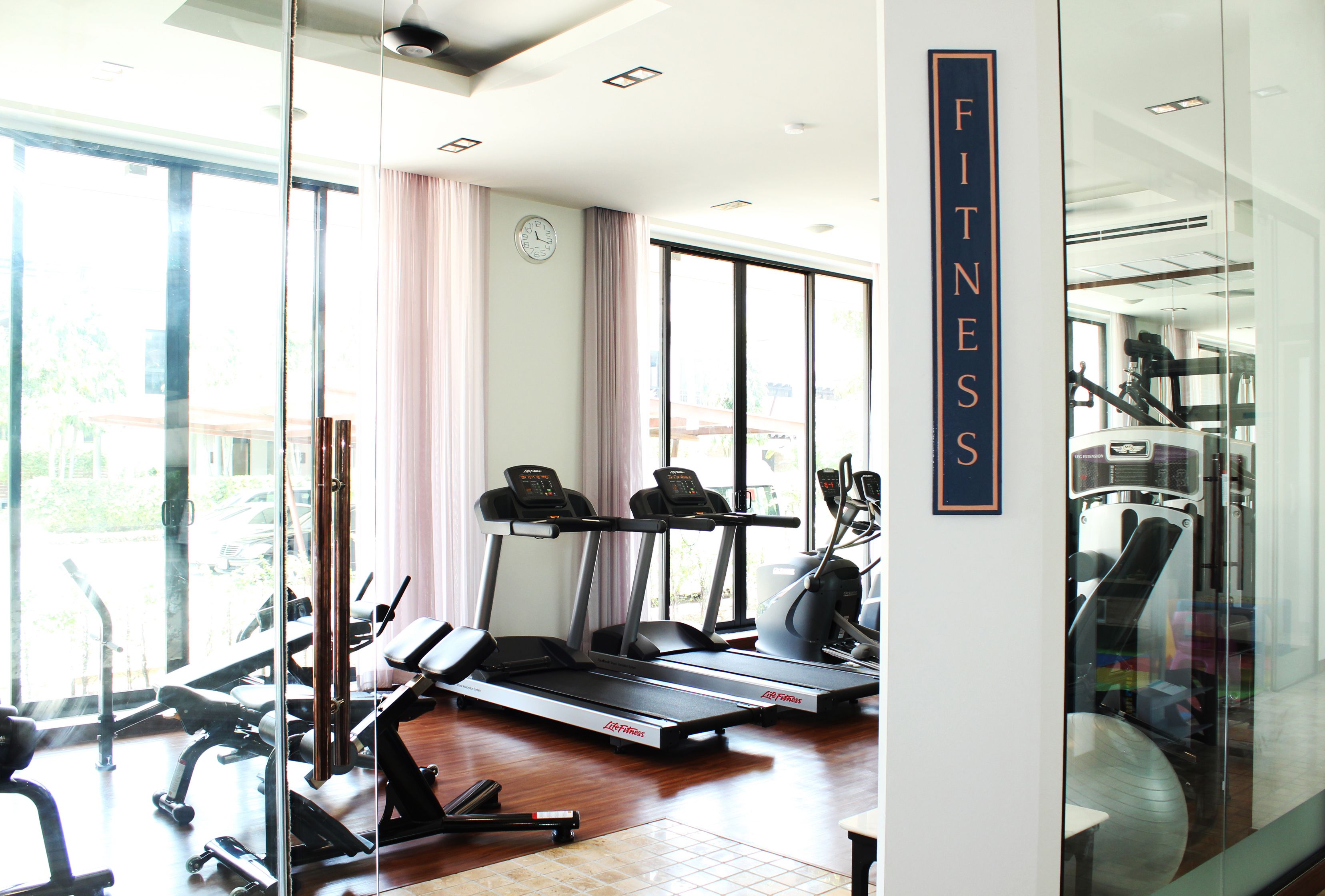 A fitness center with treadmills, exercise bikes, and free weights.