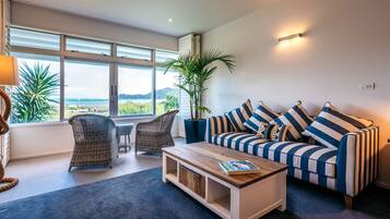 Luxury Studio Suite, 1 King Bed, Sea View | Living area | 49-inch Smart TV with satellite channels, TV, Netflix