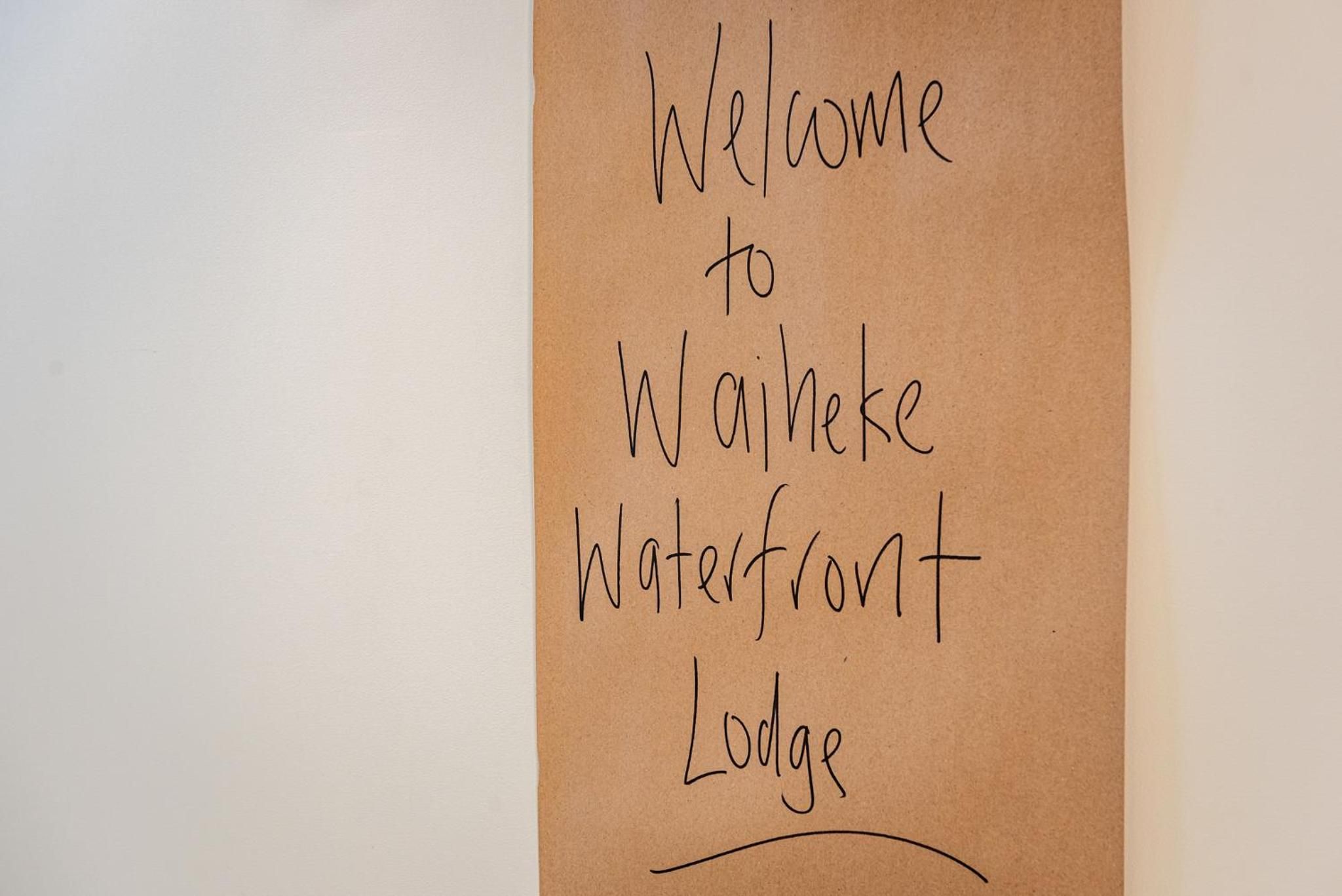 A handwritten sign welcoming visitors to Waterfront Lodge.