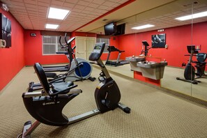 A gym with stationary bikes, treadmills, and exercise equipment.