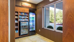 A corner market with refrigerated beverage dispensers and shelves stocked with snacks and beverages. - Fairfield Inn & Suites by Marriott Columbia (Columbia)