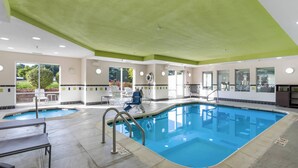 An indoor swimming pool with clear water, surrounded by lounge chairs and a sunbed. - Fairfield Inn & Suites by Marriott Columbia (Columbia)