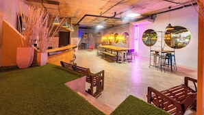 A restaurant with a bar area, seating, and decorative mirrors.