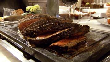 A steak on a hot plate, likely in a restaurant setting.