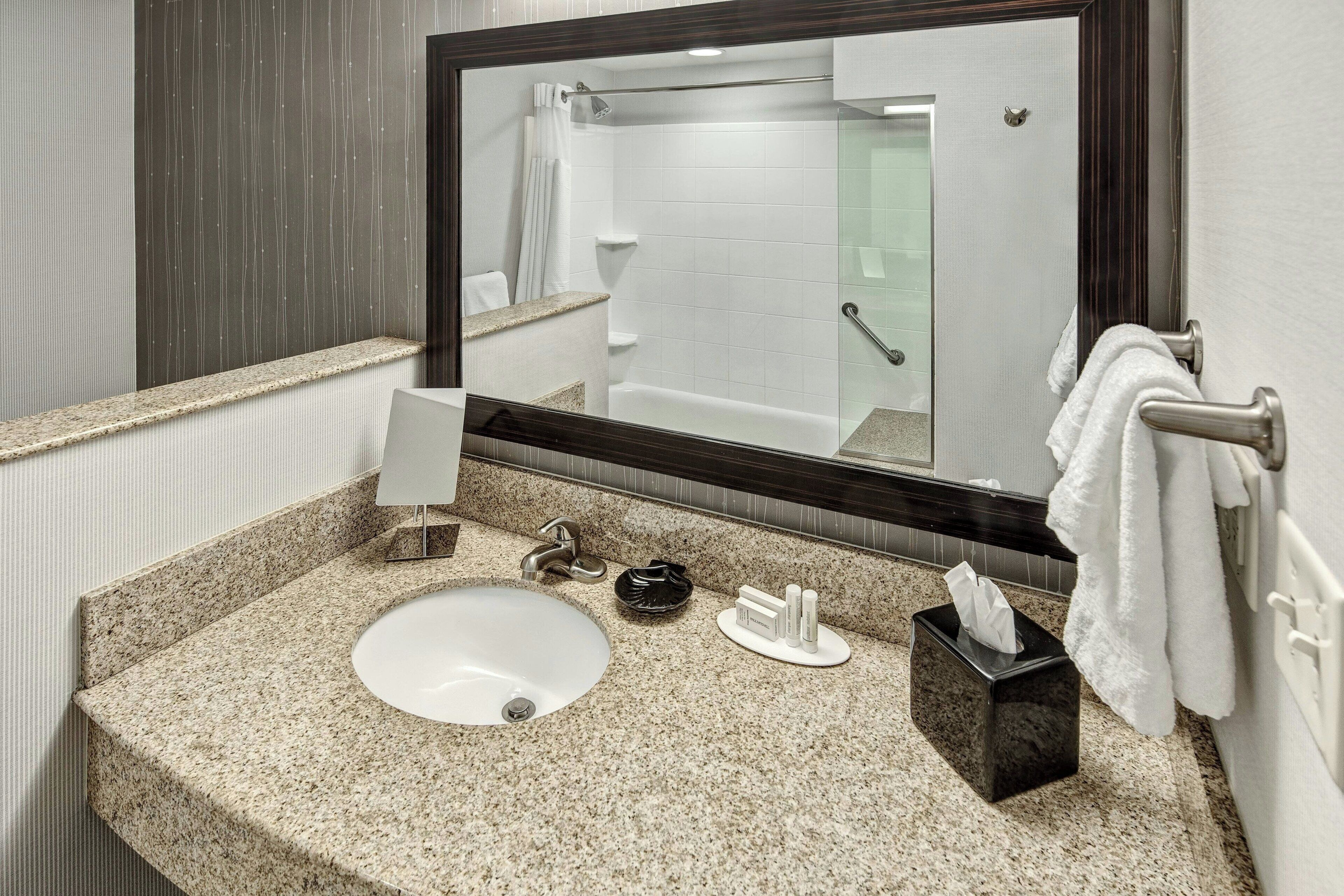 combined shower/bathtub, designer toiletries, hair dryer, towels