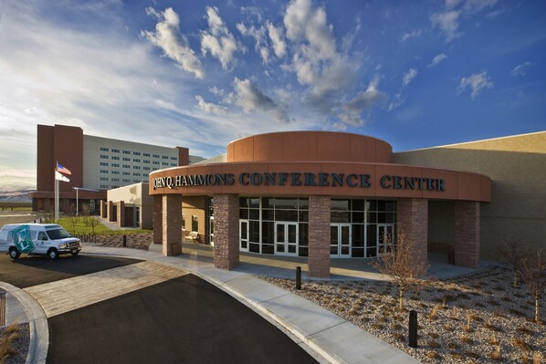 The John Q. Hammons Conference Center with a clear sky and a van parked in front. - Embassy Suites by Hilton Loveland Conference Center (Loveland)