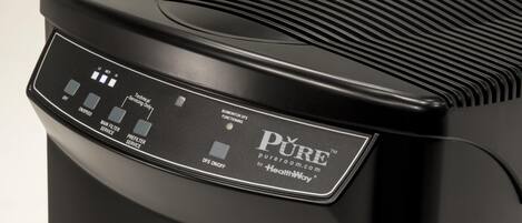 A black air purifier with a control panel displaying various service options.