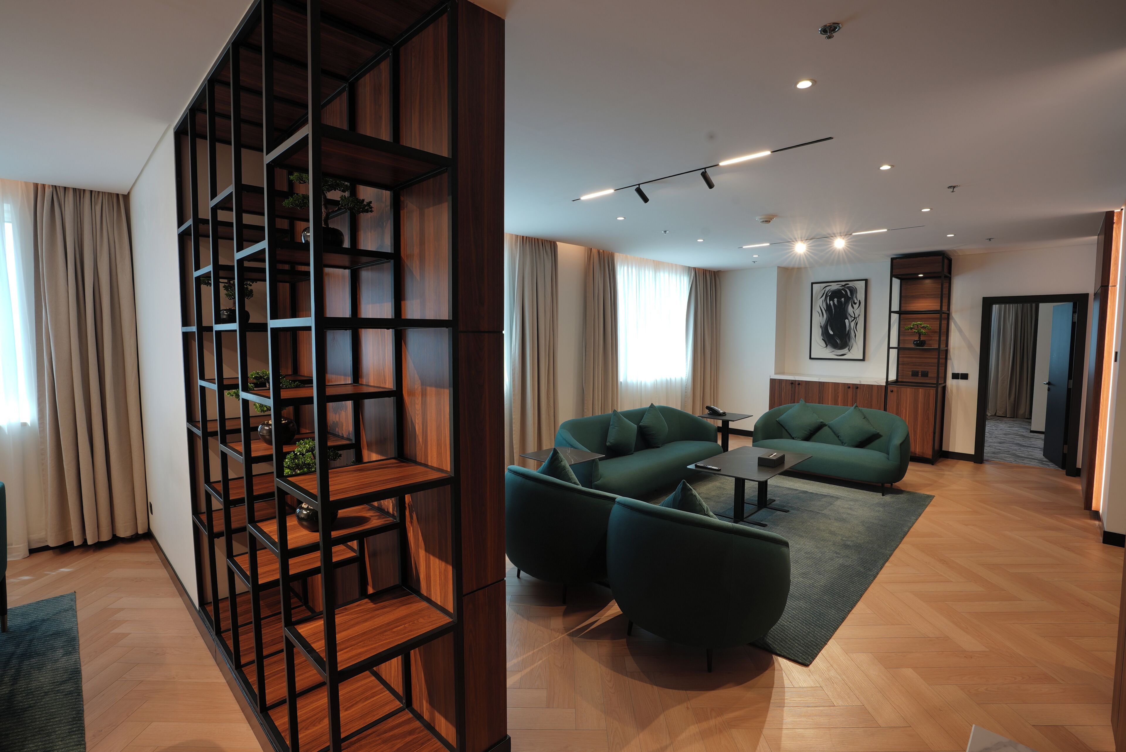 Una sala moderna con un sofá modular, una mesa de centro y una estantería de madera.