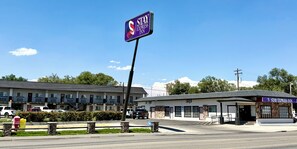A Stay Express Inn with a prominent sign, a parking lot, and a building with a covered entrance.
