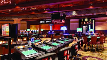 Experience the excitement of gaming at this vibrant casino, featuring a range of slots and a blackjack table.