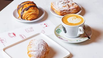 A table with pastries and a cup of coffee.
