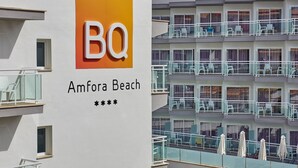 A hotel sign with the letters "BQ" and the name "Amfora Beach".