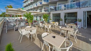 A rooftop terrace with outdoor seating and a pool.
