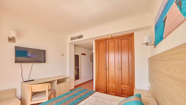 A bedroom with a bed, a desk, a television, and a wardrobe. - Ilusion Markus & Spa (Santa Margalida)