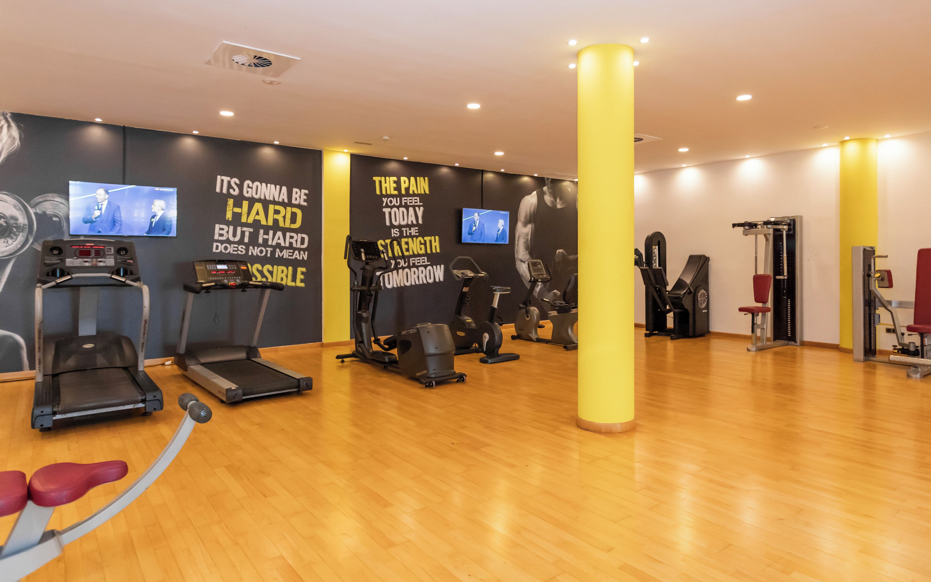 A gym with treadmills, stationary bikes, and weight machines.